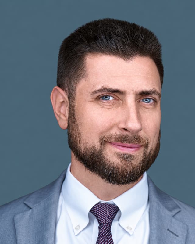Christopher J. Henke in a light gray blazer.